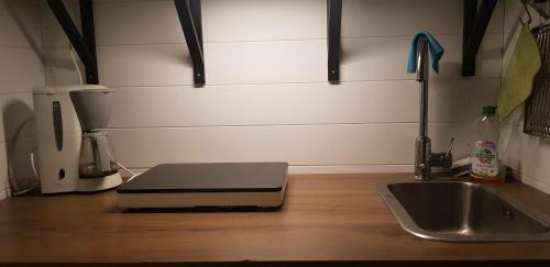a laptop sitting on top of a counter next to a sink at Romme Rum in Borlänge