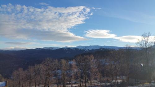 a view of a mountain range with trees and clouds at Uroczysko starych sztolni in Szklarska Poręba