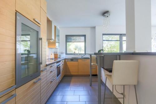 a kitchen with a table and a chair in it at IVY'S CORNER in Luxembourg