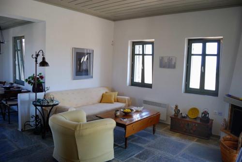 a living room with a couch and a table at Emelia in Otzias