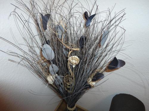a vase filled with dried grass and other items at Gasthof Reiterstuben in Hoßkirch