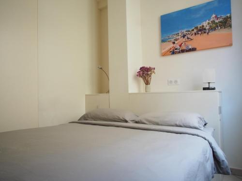 a bedroom with a bed with a picture on the wall at Nice Centre - Apartment with balcony and stunning sea view! in Nice