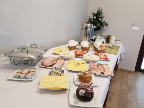 a table with many different types of food on it at DobraNocka in Małastów