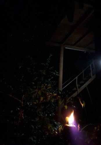 a fire burns in the dark at night at Dambulla Tree House in Dambulla