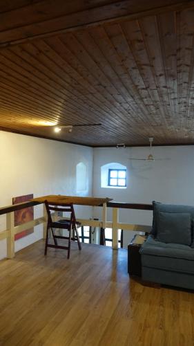 a living room with a table and a couch at The old olive mill house in Aegae