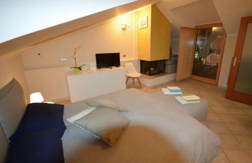 a bedroom with a large bed and a television at B&B Portanova in Salerno