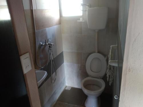 a bathroom with a shower and a toilet and a sink at Palafito in Aguas Dulces