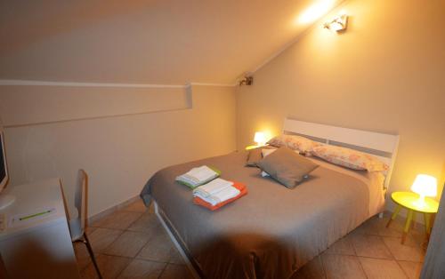 a bedroom with a bed with two pillows on it at B&B Portanova in Salerno