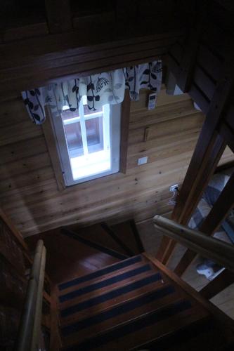 an overhead view of a wooden attic with a window at Kirvesjärven Simpukka in Rokua