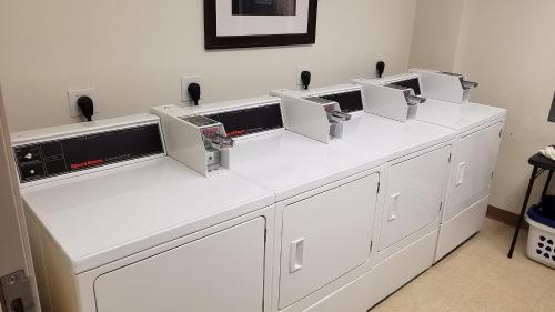 a white counter with four microwaves on top of it at Ingra House Hotel in Anchorage