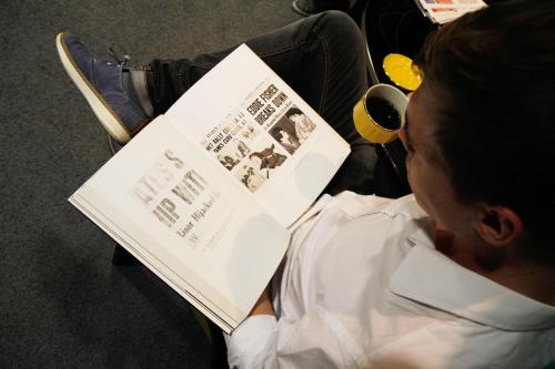 a person reading a book while sitting in a chair at Saint SHERMIN bed breakfast & champagne in Vienna
