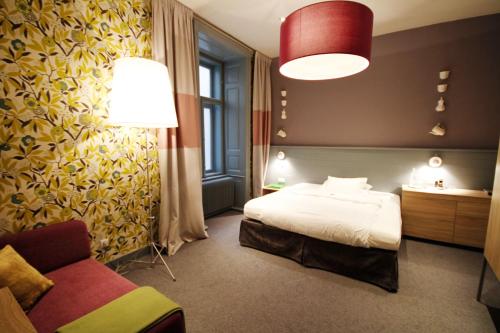 a hotel room with a bed and a couch at Saint SHERMIN bed breakfast & champagne in Vienna