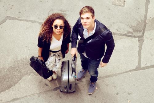a man and a woman standing with a suitcase at Saint SHERMIN bed breakfast & champagne in Vienna