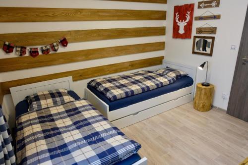 A bed or beds in a room at Apartmány BD Boží Dar