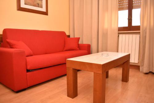 a living room with a red couch and a table at Hotel Miravalle in Naples
