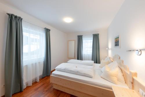 a large bed in a room with a large window at Wawies Apartments in Flachau