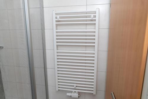 a white shutter on a shower in a bathroom at Wawies Apartments in Flachau