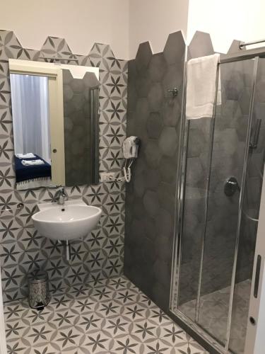a bathroom with a sink and a shower at Ai Tre Mercati in Palermo