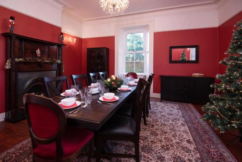 a dining room with a table and a christmas tree at Manor House - Hot Tub House for max 10 people in Birtley