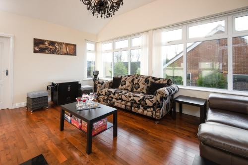 a living room with a couch and a table at Manor House - Hot Tub House for max 10 people in Birtley