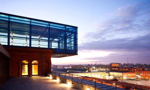 a building with a walkway on top of it at Vienna House by Wyndham Andel's Lodz in Łódź