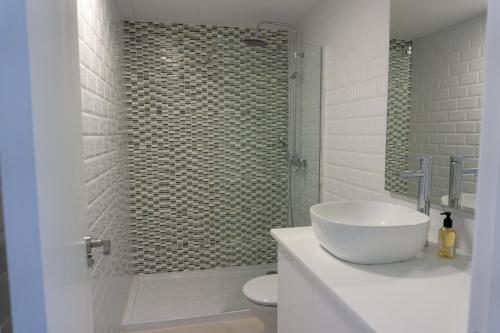 een badkamer met een wastafel en een douche met een toilet bij Apartment Sea View Playa del Ingles in Playa del Inglés