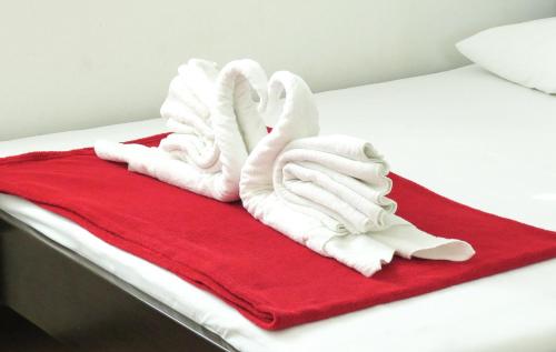 a bed with white towels on a red blanket at VILLA DARIA in Pakoštane