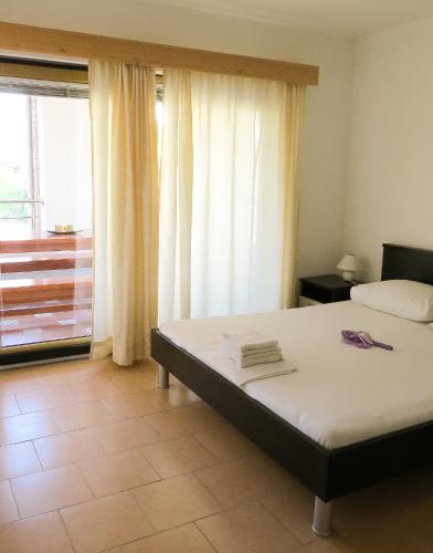 a bedroom with a bed and a large window at VILLA DARIA in Pakoštane