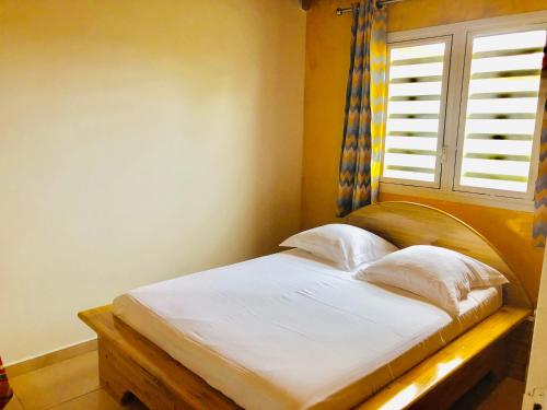 מיטה או מיטות בחדר ב-Gîte étoile du matin Grand-bourg de Marie-galante