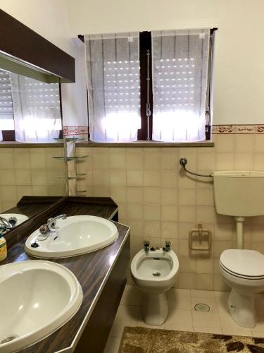 a bathroom with two sinks and a toilet at Lines of Wellignton in Torres Vedras