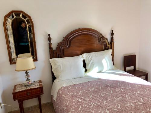 a bedroom with a bed and a mirror and a table at Lines of Wellignton in Torres Vedras