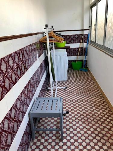 a blue bench sitting on a tiled floor in a room at Lines of Wellignton in Torres Vedras