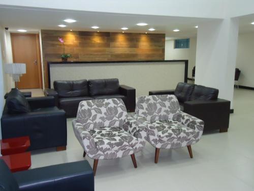 a living room with two chairs and a couch at Varadero Palace Hotel in Florianópolis