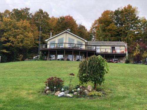 a large house on a hill with a yard at Our Valley View Bed & Breakfast in Hampton