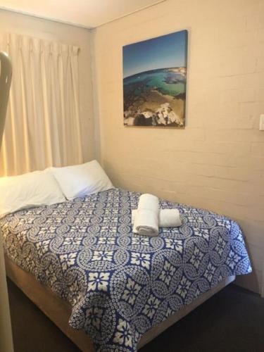 a bedroom with a bed with two towels on it at Riverview Holliday villa with River Views and Pool in Kalbarri