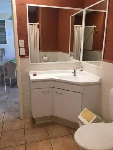 a bathroom with a sink and a toilet and a mirror at Riverview Holliday villa with River Views and Pool in Kalbarri
