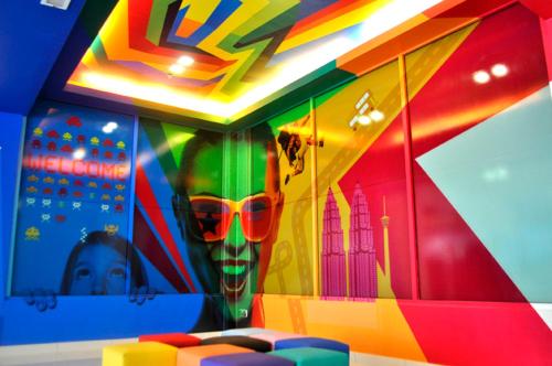 a room with a colorful wall with a skull and a baby at YY318 Hotel Bukit Bintang in Kuala Lumpur