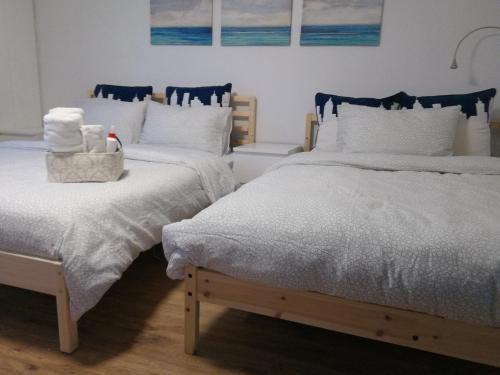 two beds sitting next to each other in a bedroom at Margie Townhome Suites in Toronto