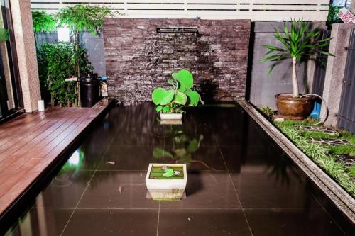 a courtyard with potted plants on the floor of a building at D Day Suite in Bangkok