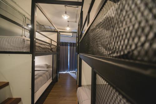a room with two bunk beds and a hallway at Chernchan Hostel in Chanthaburi