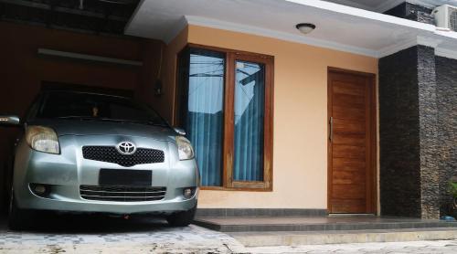 a silver car parked in front of a house at Homestay / Guest House Dekat Malioboro in Yogyakarta