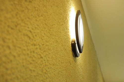 a close up of a yellow wall with a screw at Anna Residency in Nedumbassery