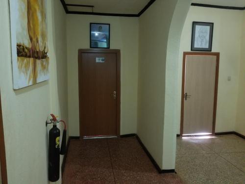 a hallway with two elevators and a door in a building at Nass Lodge in Sunyani