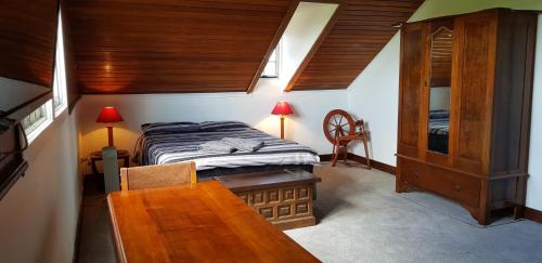 a bedroom with a bed and a table and a chair at Barrington Church B&B in Barrington