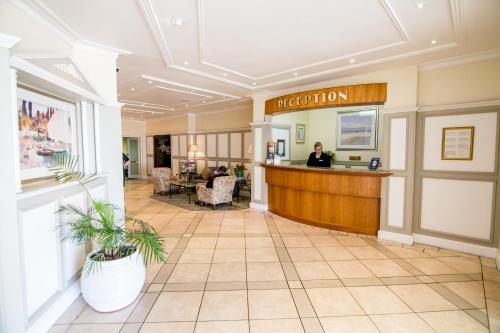 a lobby of a hotel with a reception desk at The Beach Hotel in Port Elizabeth