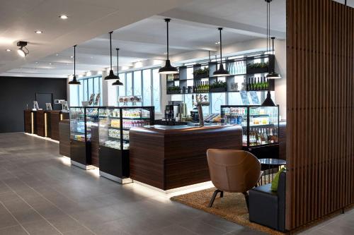 a restaurant with a bar and a chair in a room at Wakeup Copenhagen - Bernstorffsgade in Copenhagen