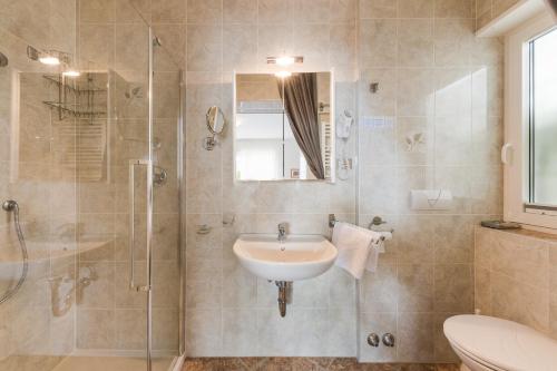 a bathroom with a sink and a shower at Pension Monika in Lagundo