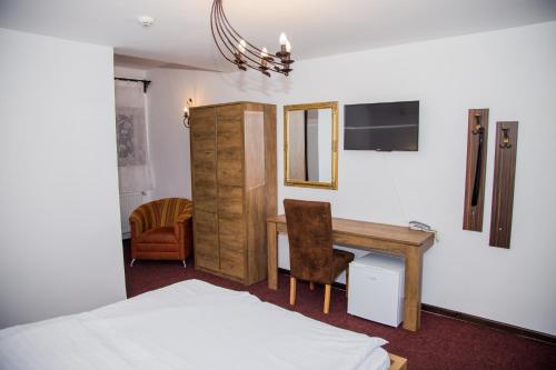 a bedroom with a desk and a bed and a desk and chair at Motel Davios in Târgu Jiu