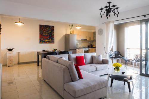 a living room with a couch and a table at Holy Paraskevi Apartment in Agios Nikolaos