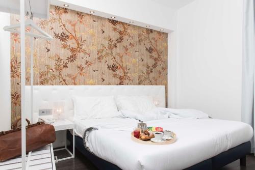 a bedroom with a bed with a tray of food on it at Hotel Montestella in Salerno